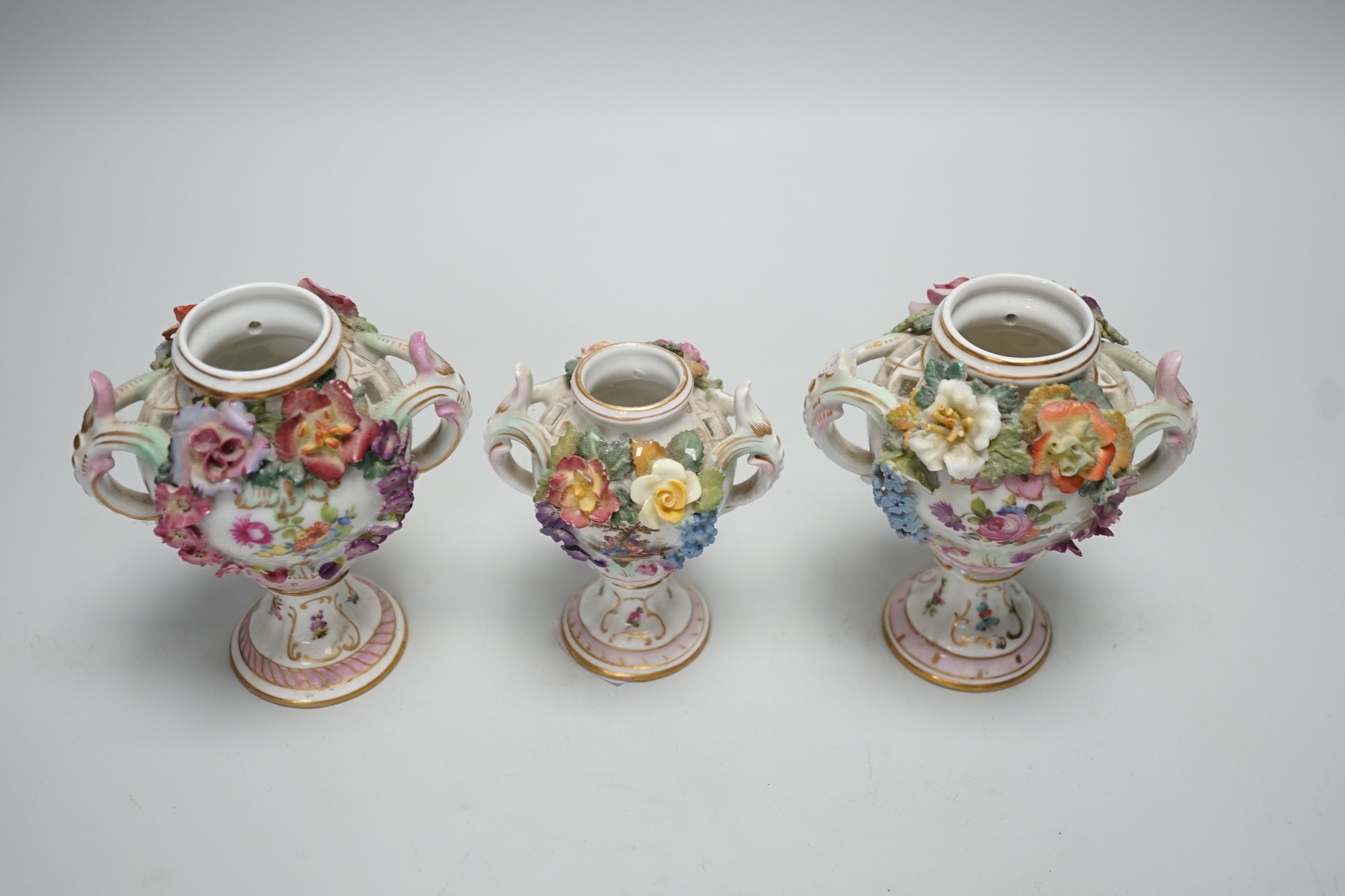 Three 19th century Dresden floral encrusted vases, two with covers, 16cm
